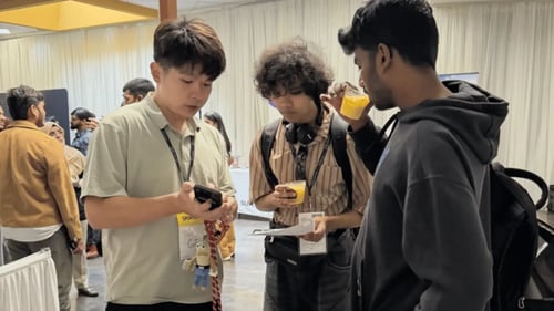 GoElite team member, Dean Liu, speaks with international students during the Open Atlas Summit in Milpitas, California.